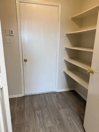 a view of room with wooden floor