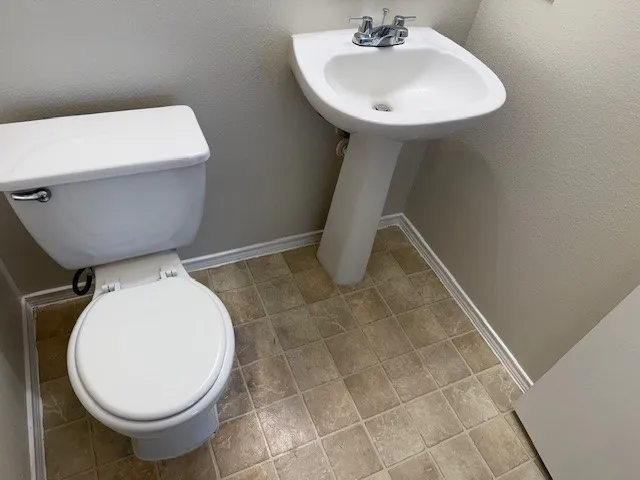 a bathroom with a sink toilet and a mirror