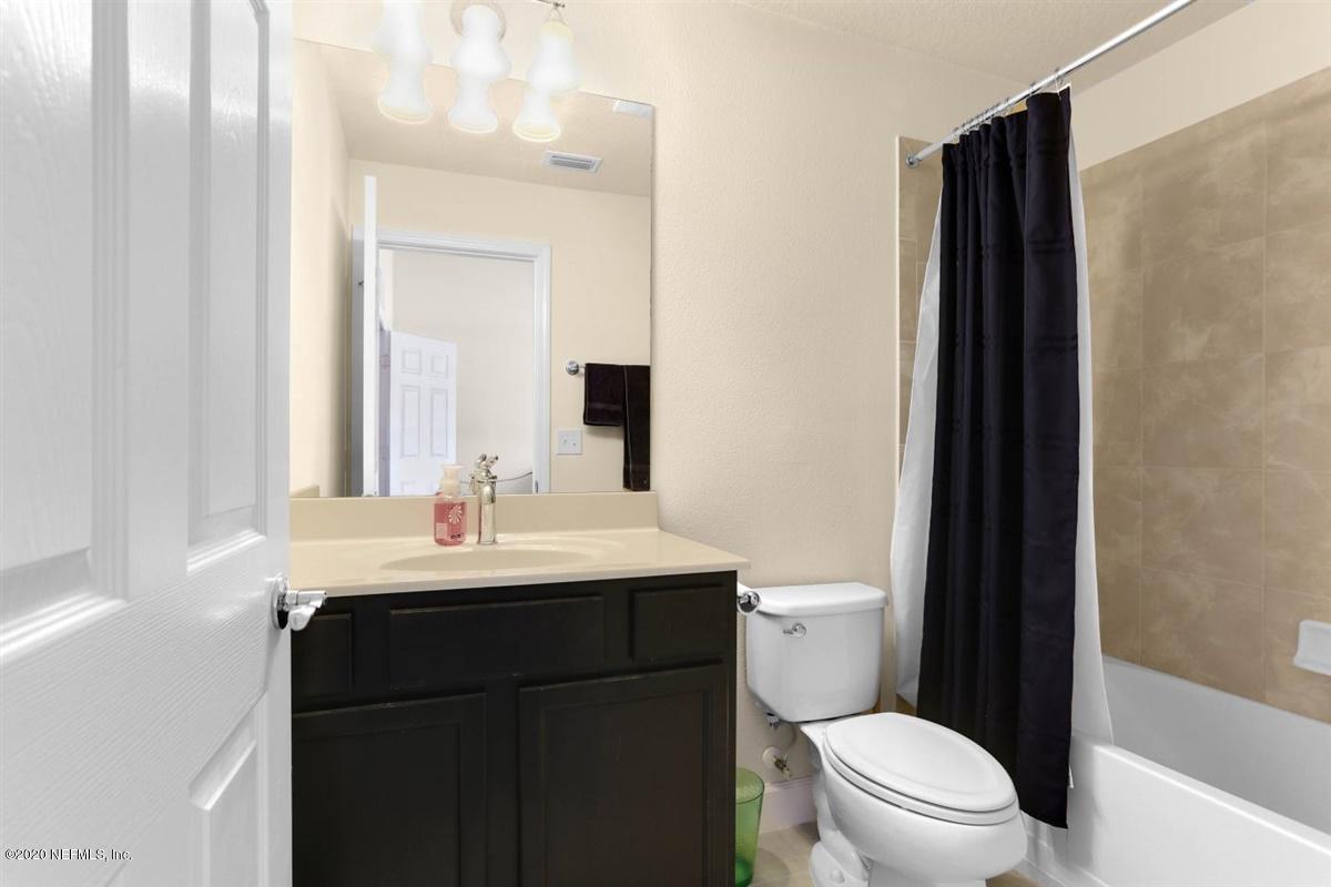 6864 Roundleaf Drive Jacksonville, FL 32258 - Photo 11 of 17 a bathroom with a sink a toilet a mirror and shower