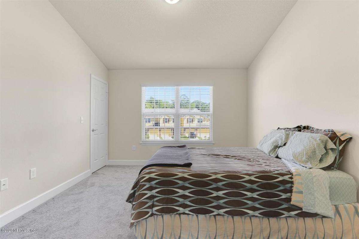 6864 Roundleaf Drive Jacksonville, FL 32258 - Photo 12 of 17 a bedroom with a bed and a window