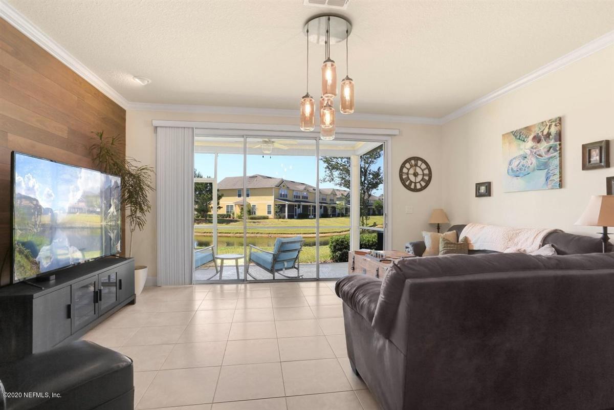 6864 Roundleaf Drive Jacksonville, FL 32258 - Photo 2 of 17 a living room with furniture and a flat screen tv