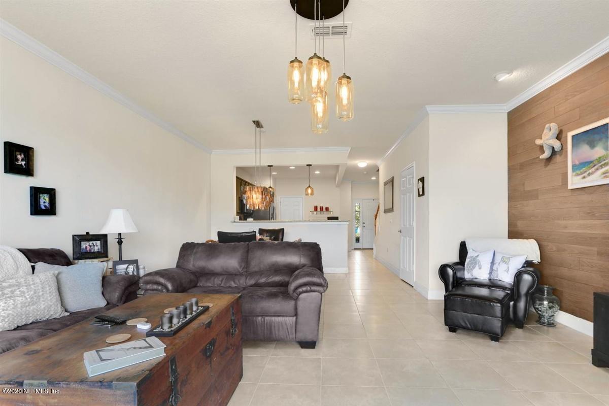 6864 Roundleaf Drive Jacksonville, FL 32258 - Photo 3 of 17 a living room with furniture and a chandelier