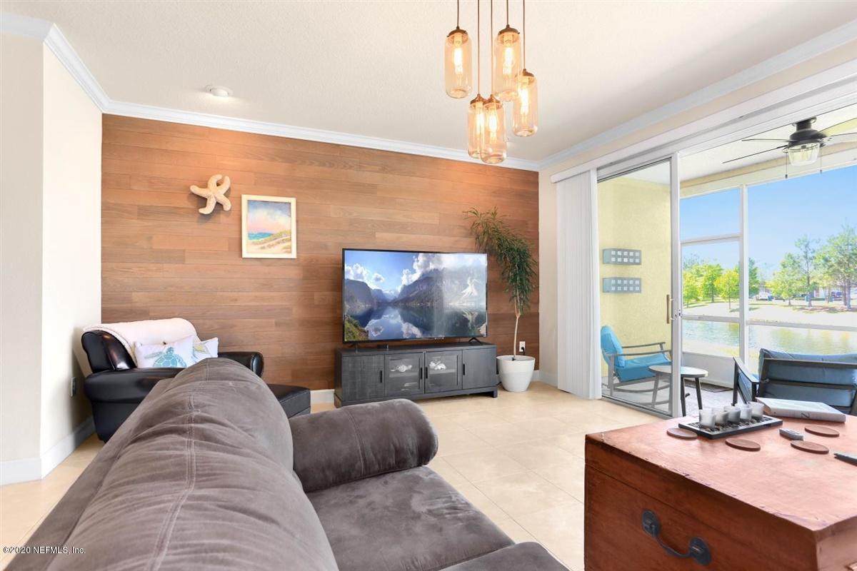 6864 Roundleaf Drive Jacksonville, FL 32258 - Photo 4 of 17 a living room with furniture and a flat screen tv