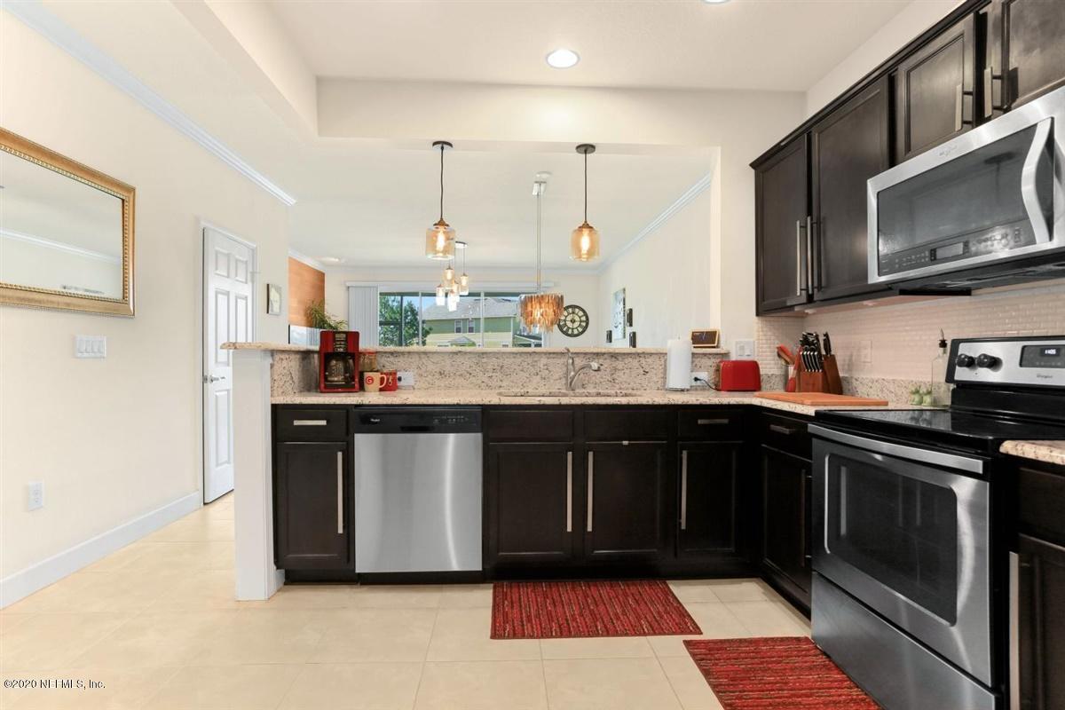 6864 Roundleaf Drive Jacksonville, FL 32258 - Photo 6 of 17 a kitchen with stainless steel appliances granite countertop a stove a sink dishwasher and a microwave oven with cabinets