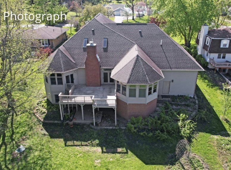 408 South Spring Lake Road Mahomet, IL 61853 - Photo 11 of 64 a aerial view of a house with table and chairs under an umbrella