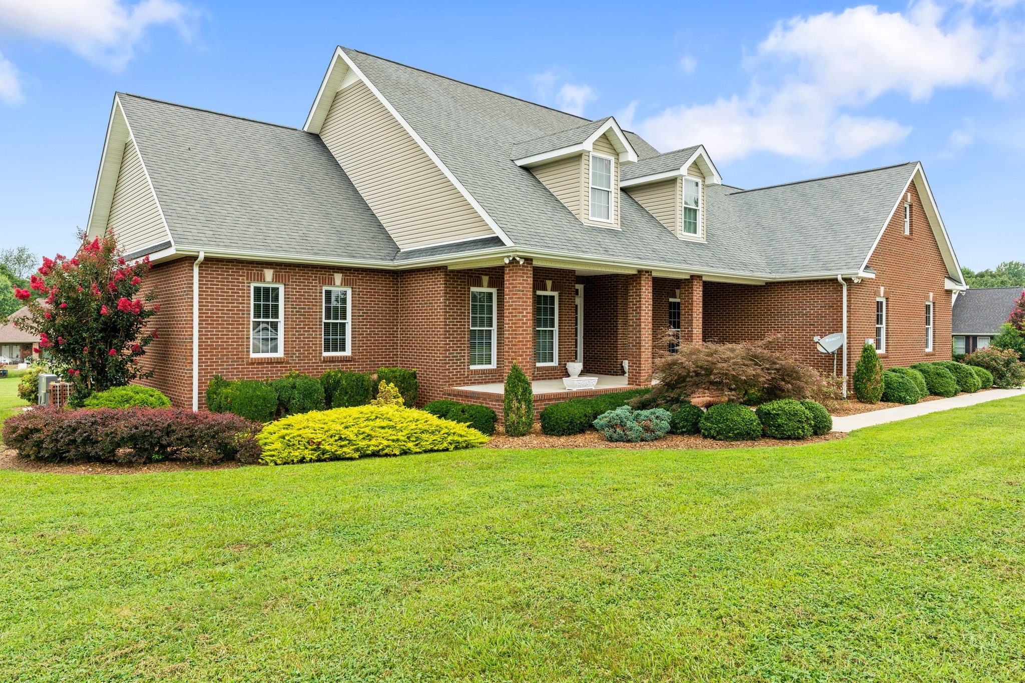 a front view of a house with garden