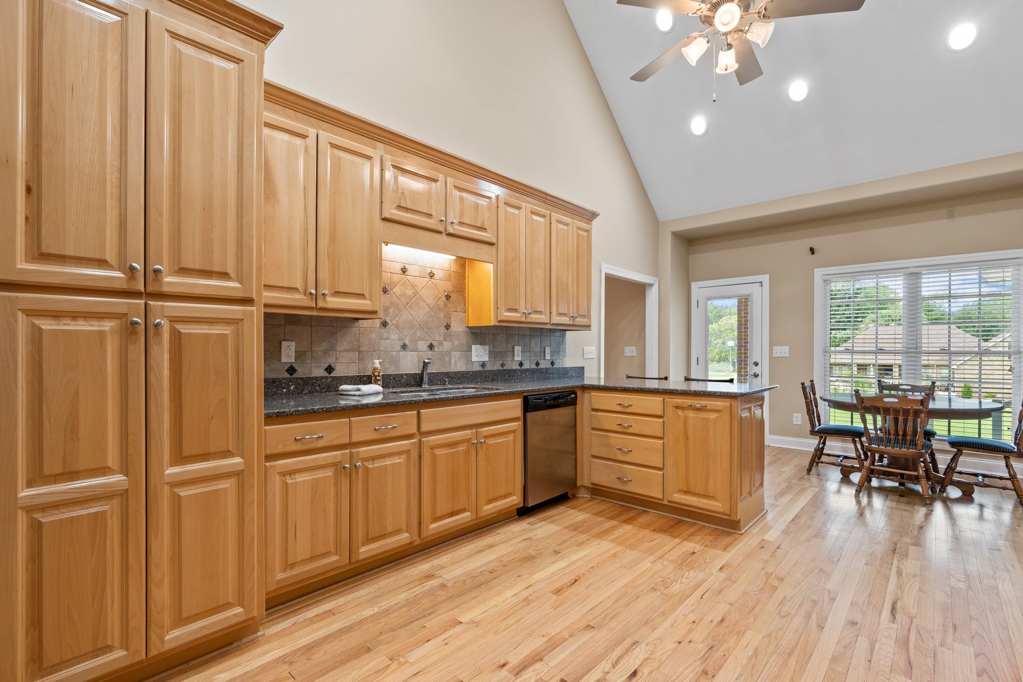 545 Pickney Road Winchester, TN 37398 - Photo 11 of 39 a large kitchen with kitchen island granite countertop a window a sink and stainless steel appliances