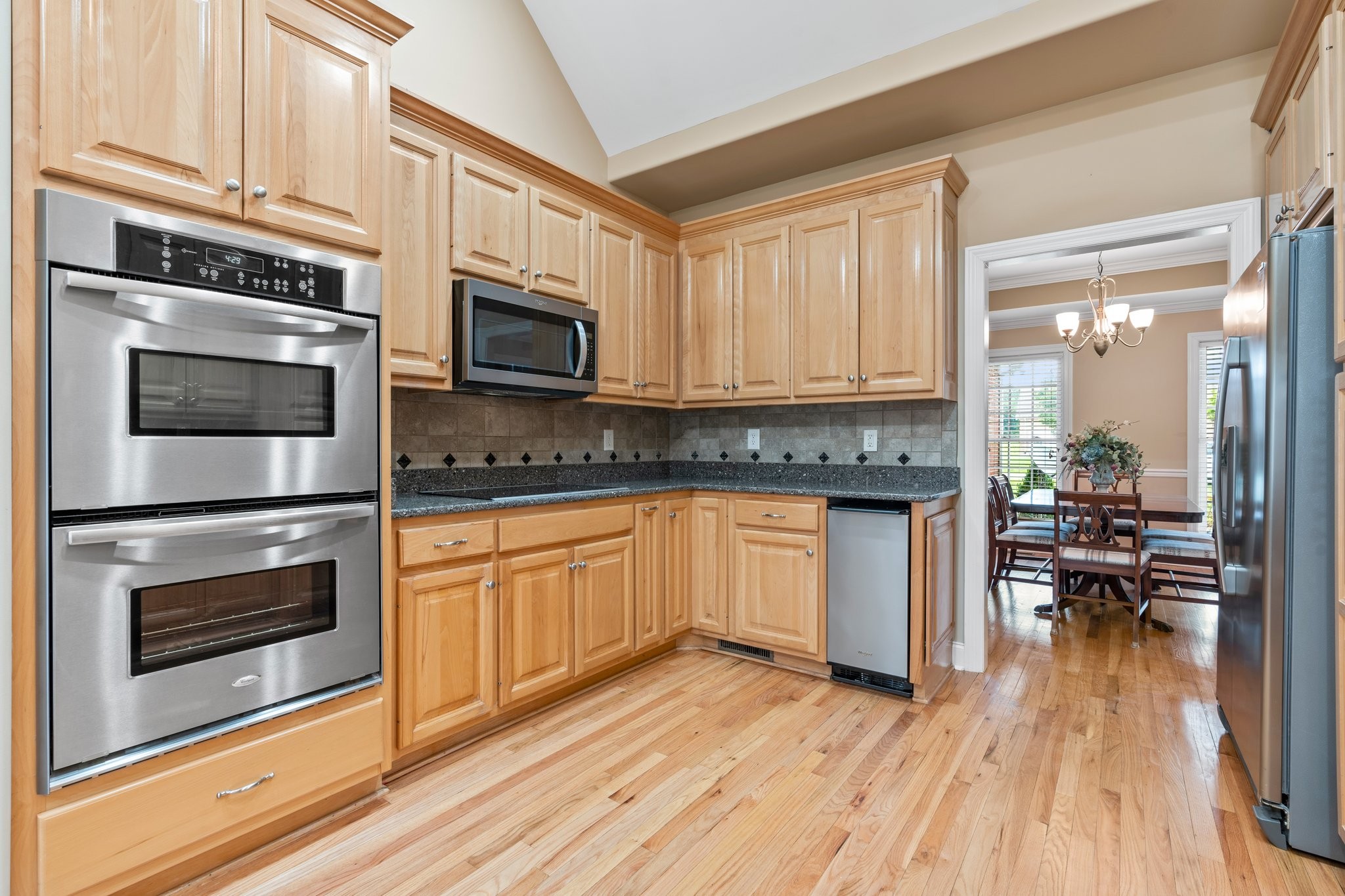 545 Pickney Road Winchester, TN 37398 - Photo 12 of 39 a kitchen with granite countertop wooden floors stainless steel appliances and sink
