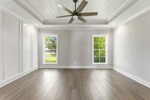 wooden floor in an empty room with a window