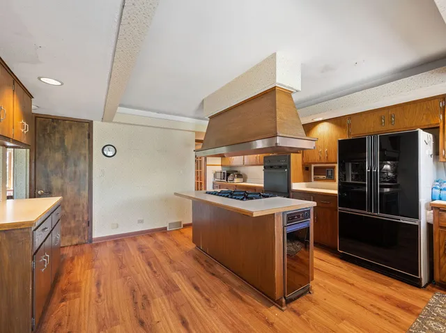 a kitchen with a stove refrigerator and a sink
