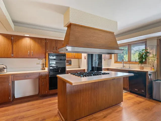 a kitchen with stainless steel appliances granite countertop a stove and a sink