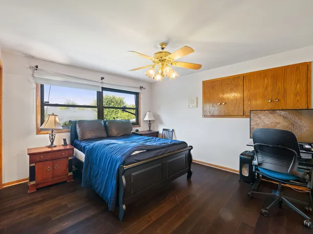 a bed room with a bed and a chair