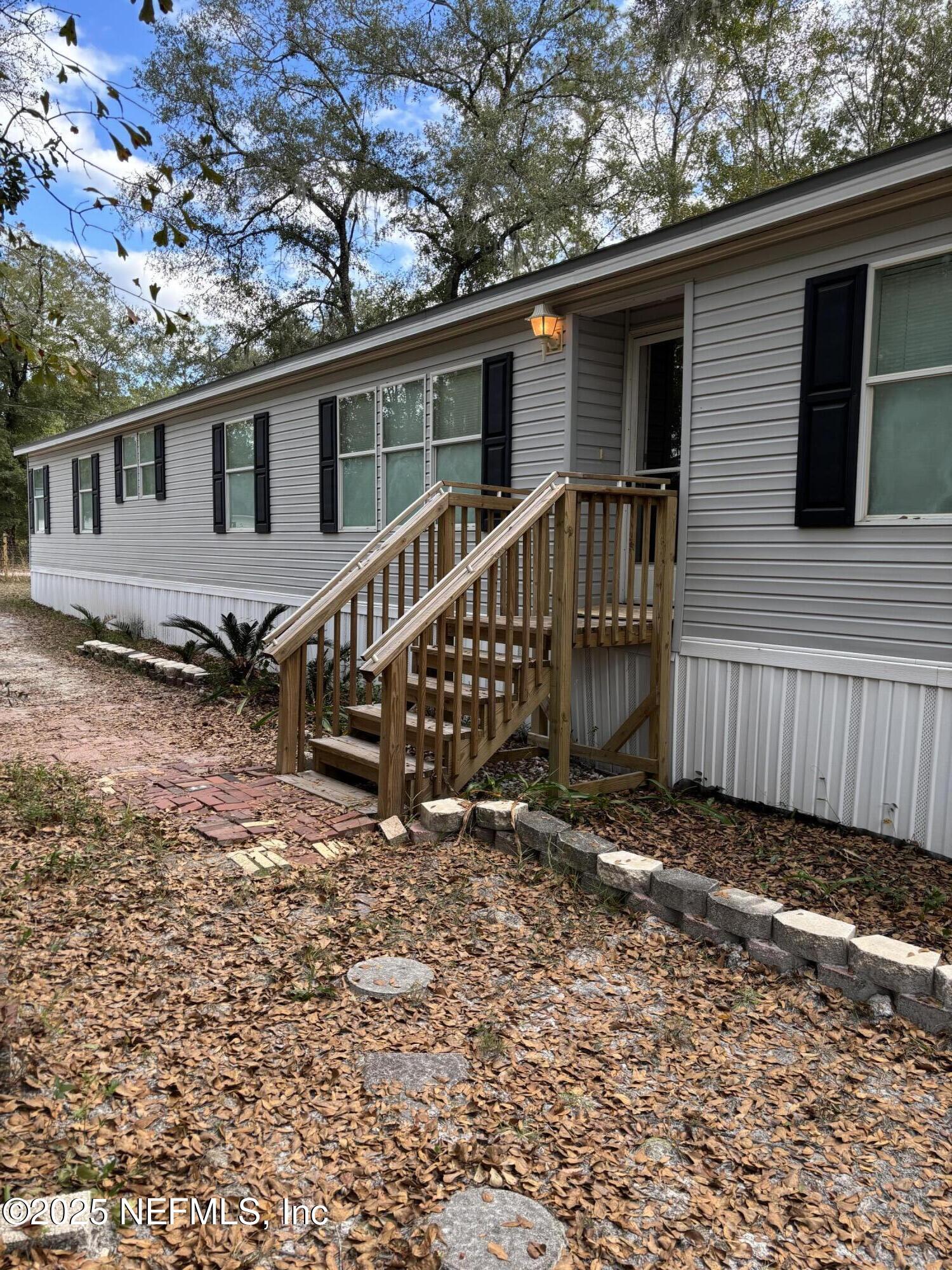 4667 Peppergrass Street Middleburg, FL 32068 - Photo 4 of 14 a backyard of a house with wooden deck