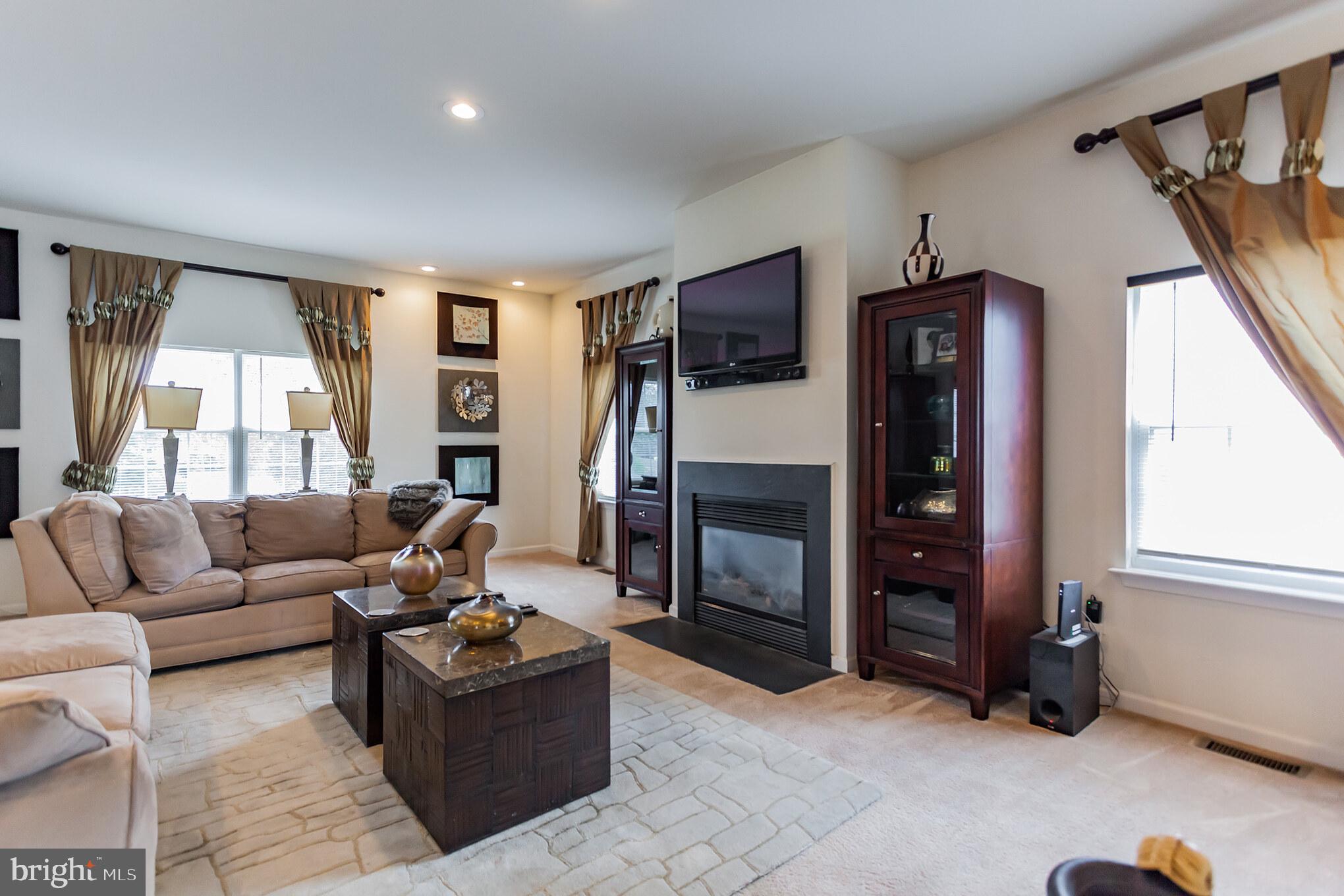 9428 Krewstown Road Philadelphia, PA 19115 - Photo 11 of 30 a living room with furniture window and a fireplace