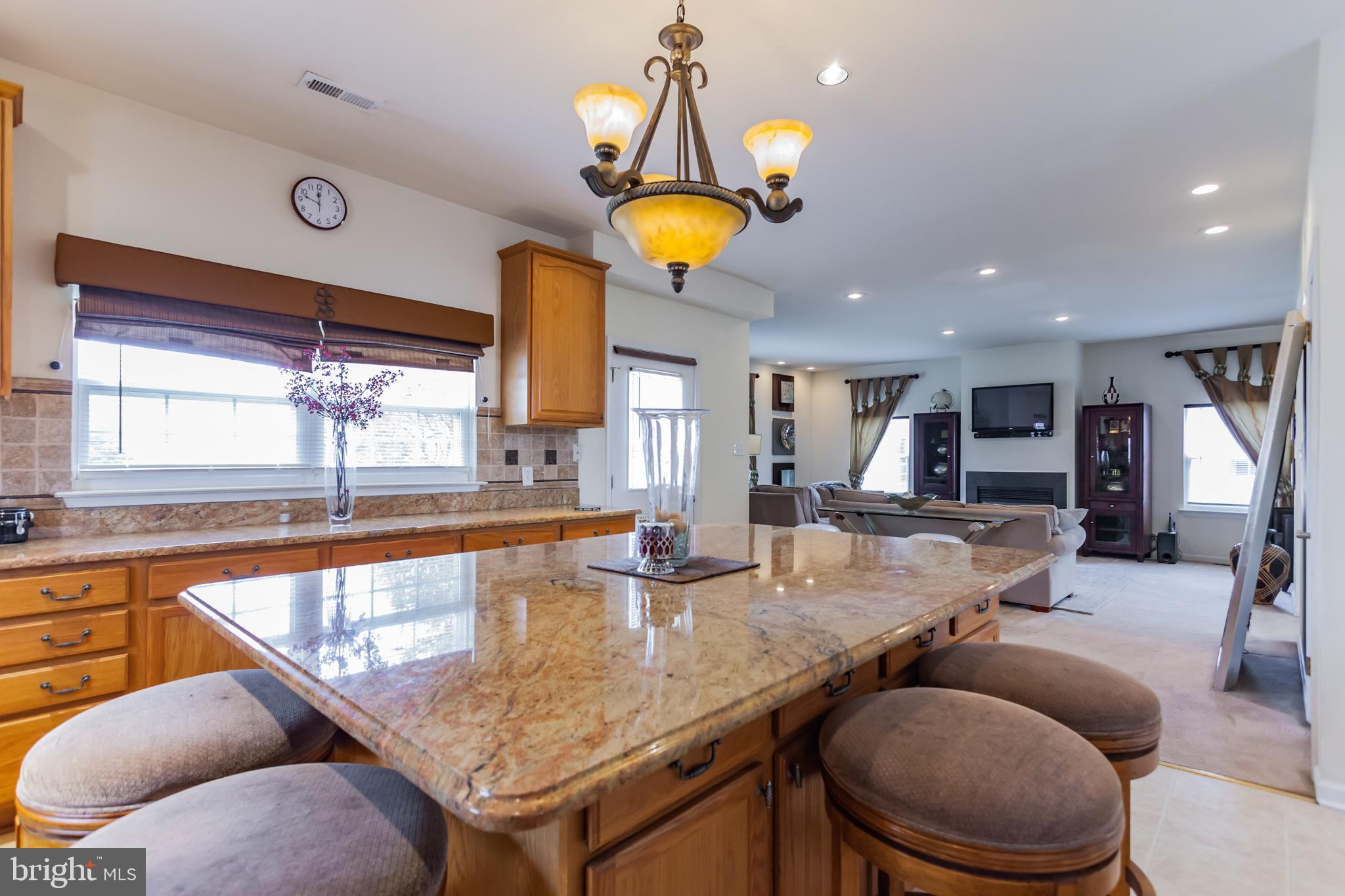 9428 Krewstown Road Philadelphia, PA 19115 - Photo 17 of 30 a kitchen with a table chairs and chandelier