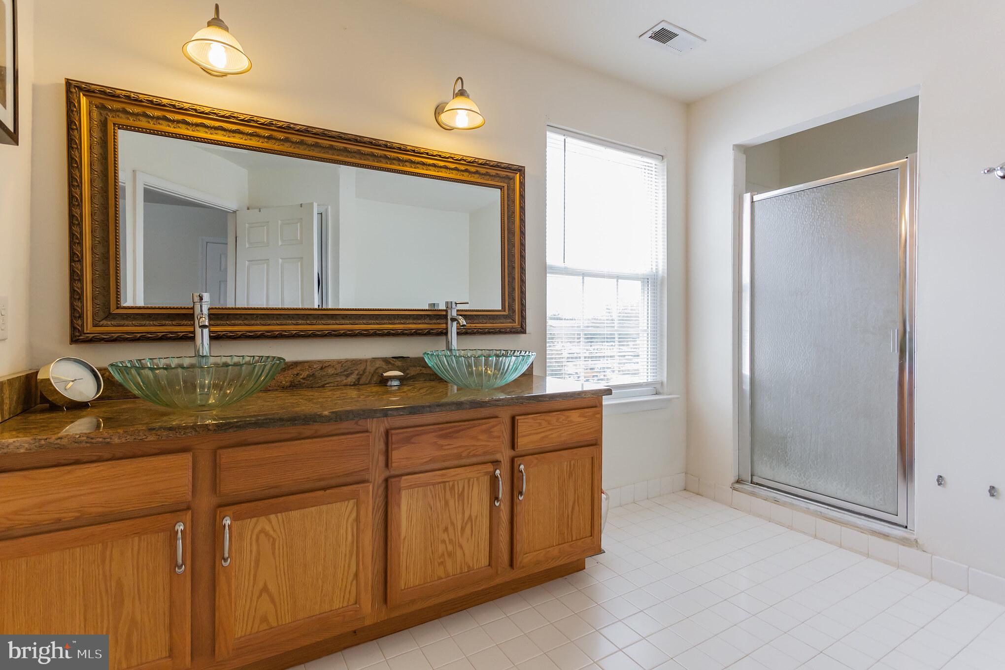 9428 Krewstown Road Philadelphia, PA 19115 - Photo 22 of 30 a bathroom with a sink and a mirror