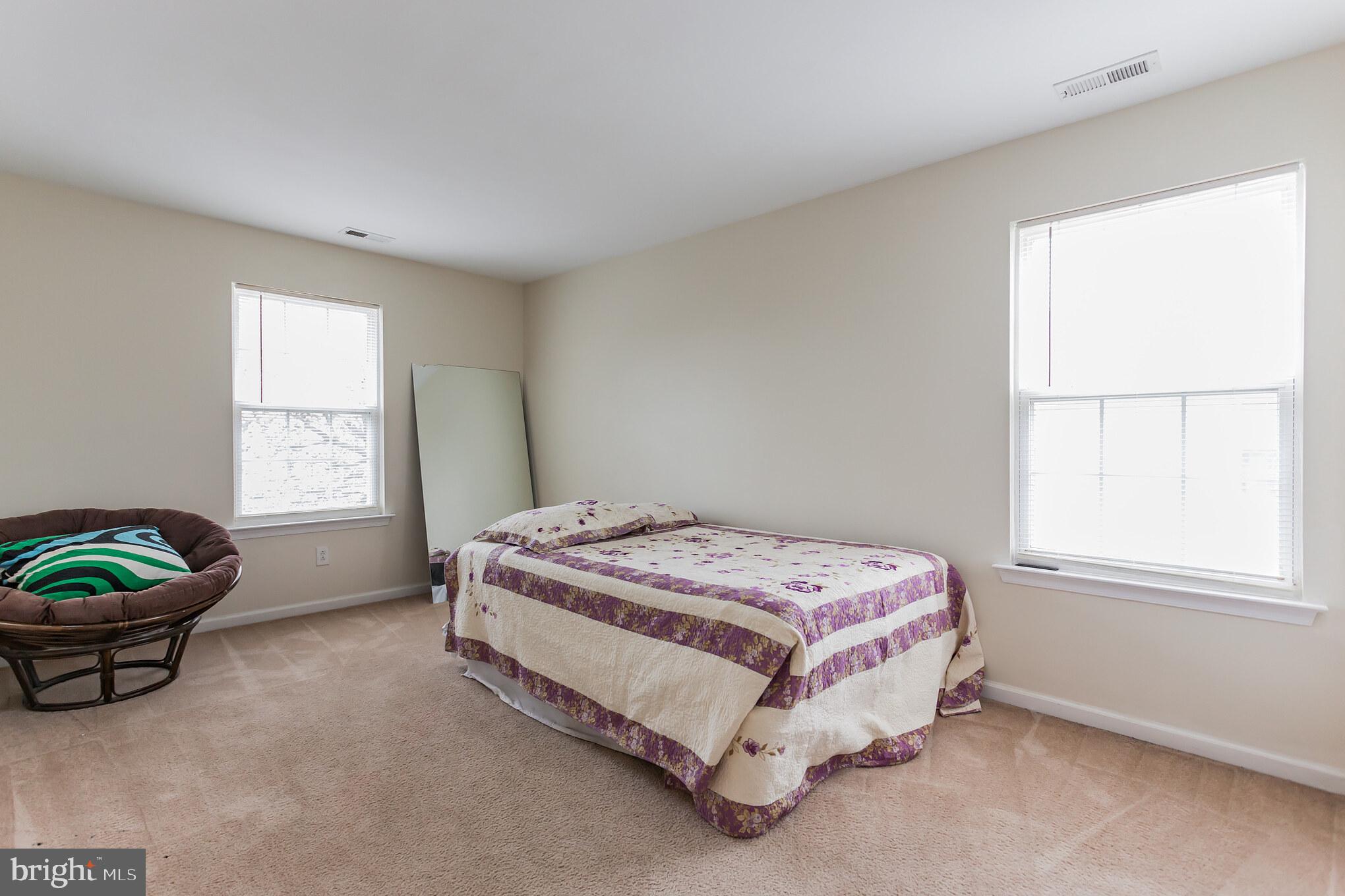 9428 Krewstown Road Philadelphia, PA 19115 - Photo 23 of 30 a spacious bedroom with a bed and a window