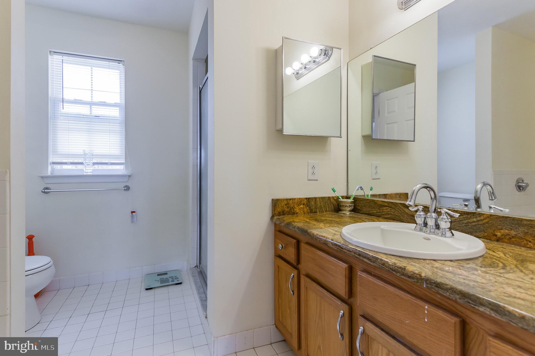 9428 Krewstown Road Philadelphia, PA 19115 - Photo 27 of 30 a bathroom with a sink double vanity and a mirror