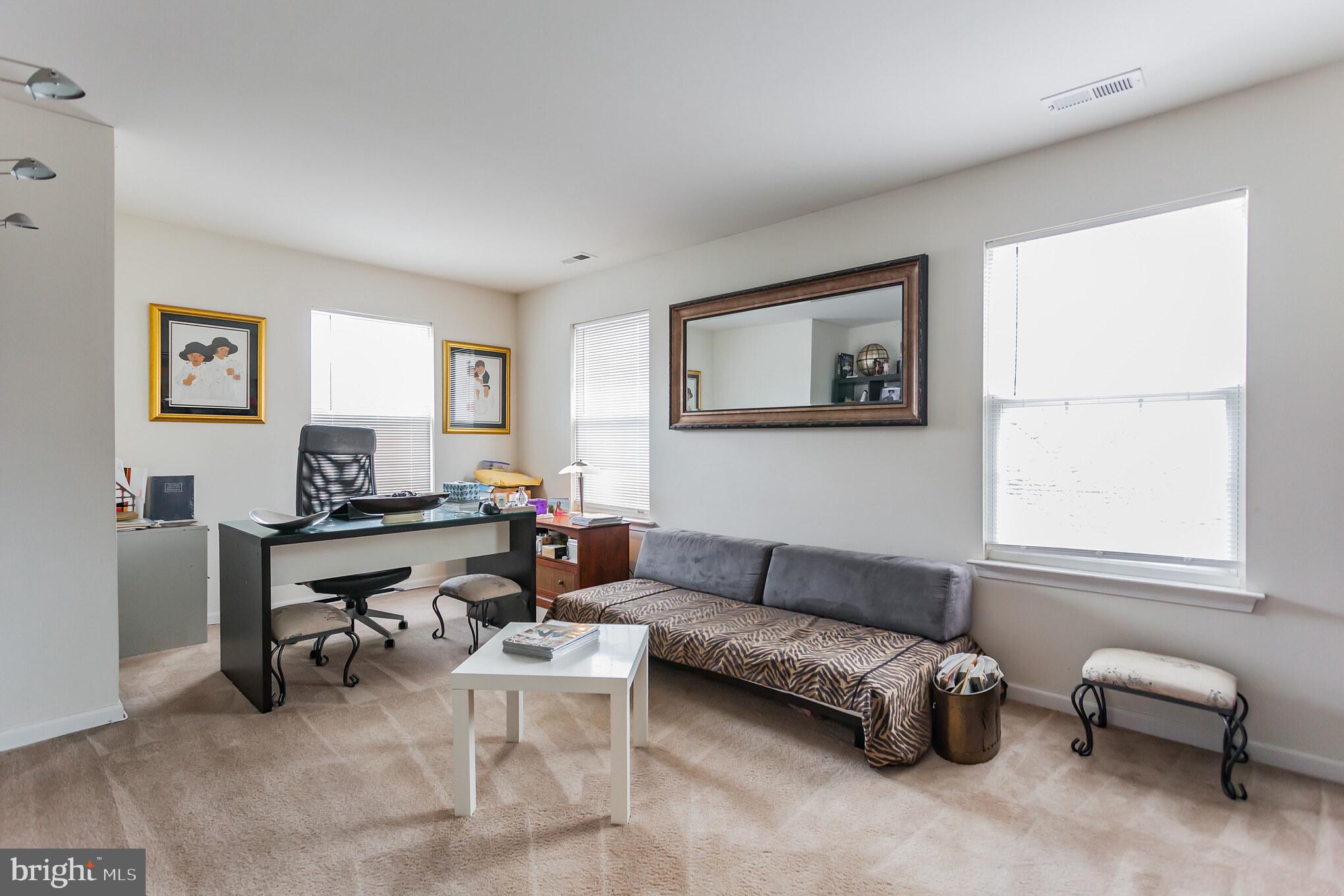 9428 Krewstown Road Philadelphia, PA 19115 - Photo 28 of 30 a living room with furniture a couch and a window