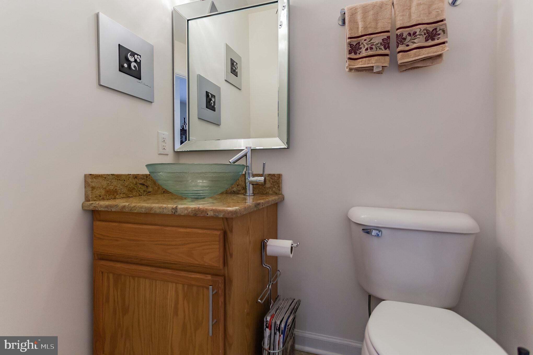 9428 Krewstown Road Philadelphia, PA 19115 - Photo 10 of 30 a bathroom with a toilet a sink and mirror