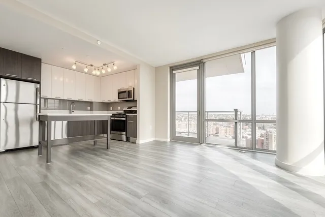 a bedroom with a large bed and a flat tv screen