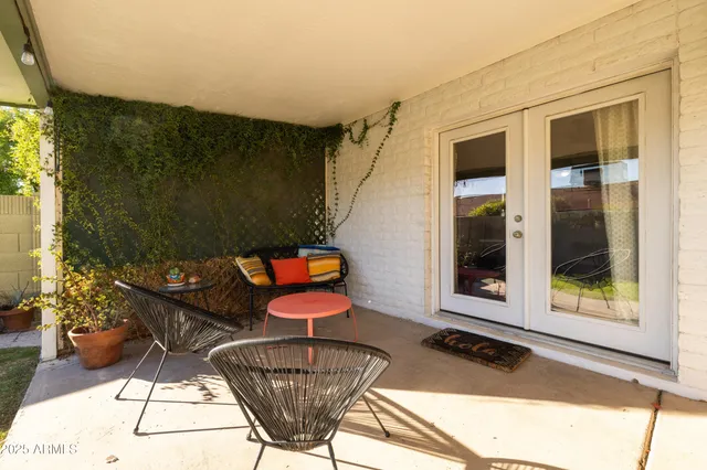 a view of a white house with a yard and plants