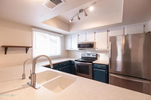 a kitchen with a refrigerator stove and microwave