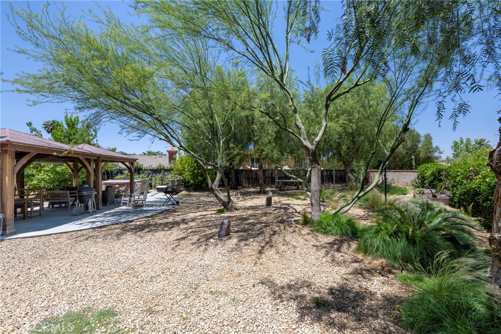 3819 St Austell Way Perris, CA 92571 - Photo 59 of 64 a view of a backyard with large trees