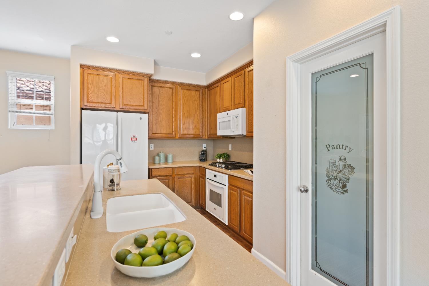 2620 Farmers Central Road Woodland, CA 95776 - Photo 15 of 32 a kitchen with a refrigerator a stove top oven a sink and cabinets