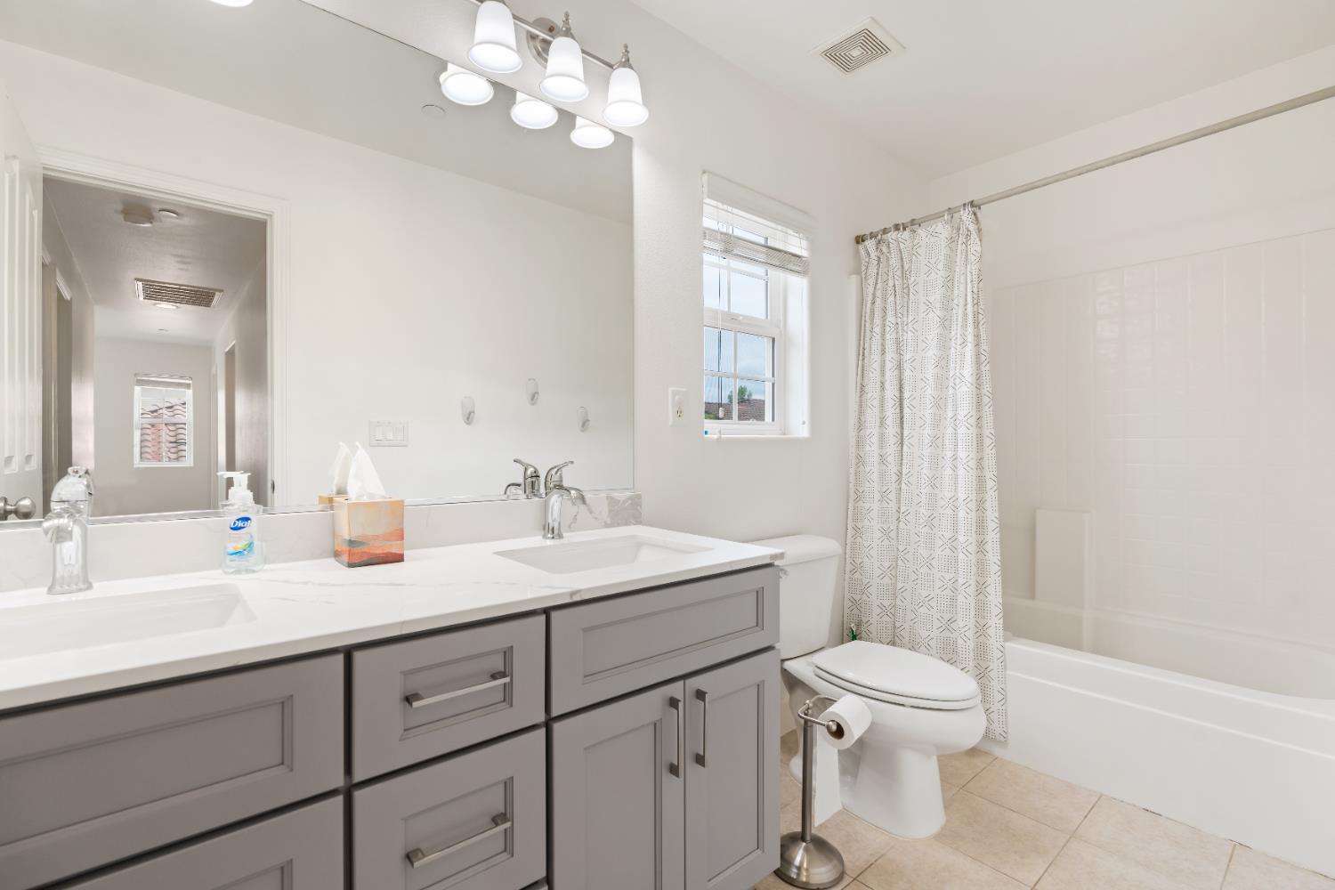 2620 Farmers Central Road Woodland, CA 95776 - Photo 23 of 32 a spacious bathroom with a granite countertop sink a toilet mirror and a bathtub