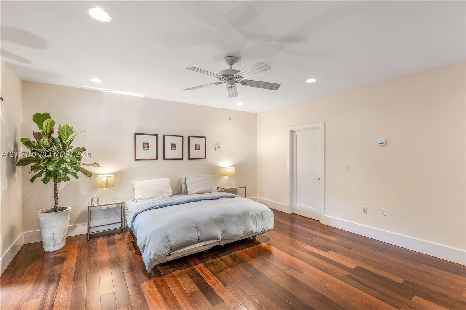 6845 Southwest 98th Street Pinecrest, FL 33156 - Photo 11 of 23 a bedroom with a large bed and a chandelier
