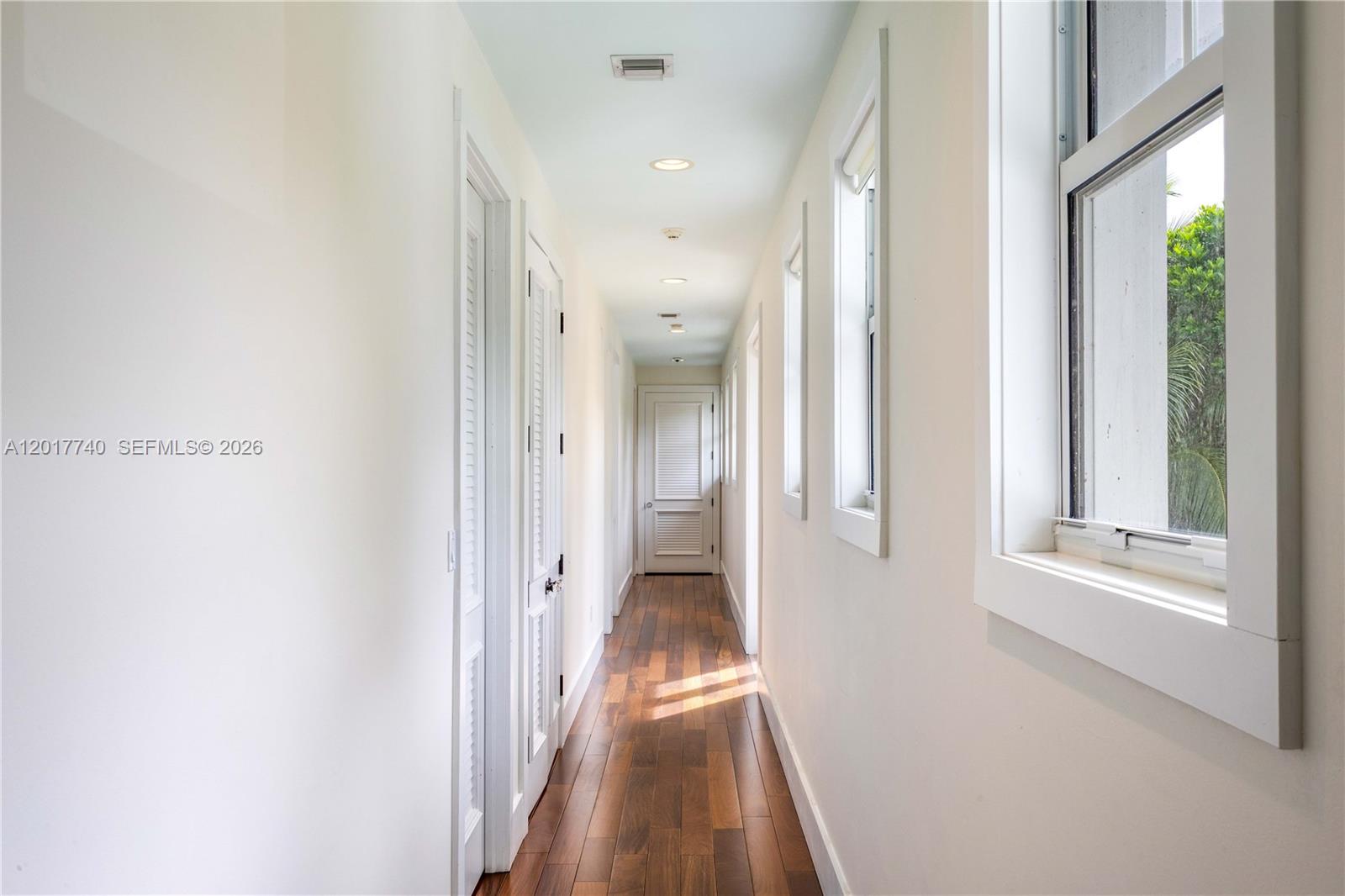 6845 Southwest 98th Street Pinecrest, FL 33156 - Photo 14 of 23 a view of a hallway with wooden floor and staircase