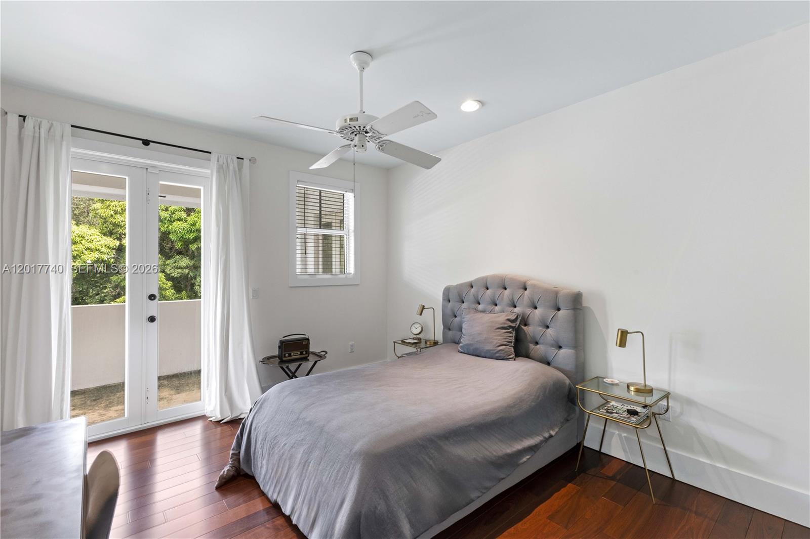6845 Southwest 98th Street Pinecrest, FL 33156 - Photo 15 of 23 a bedroom with a bed and wooden floor