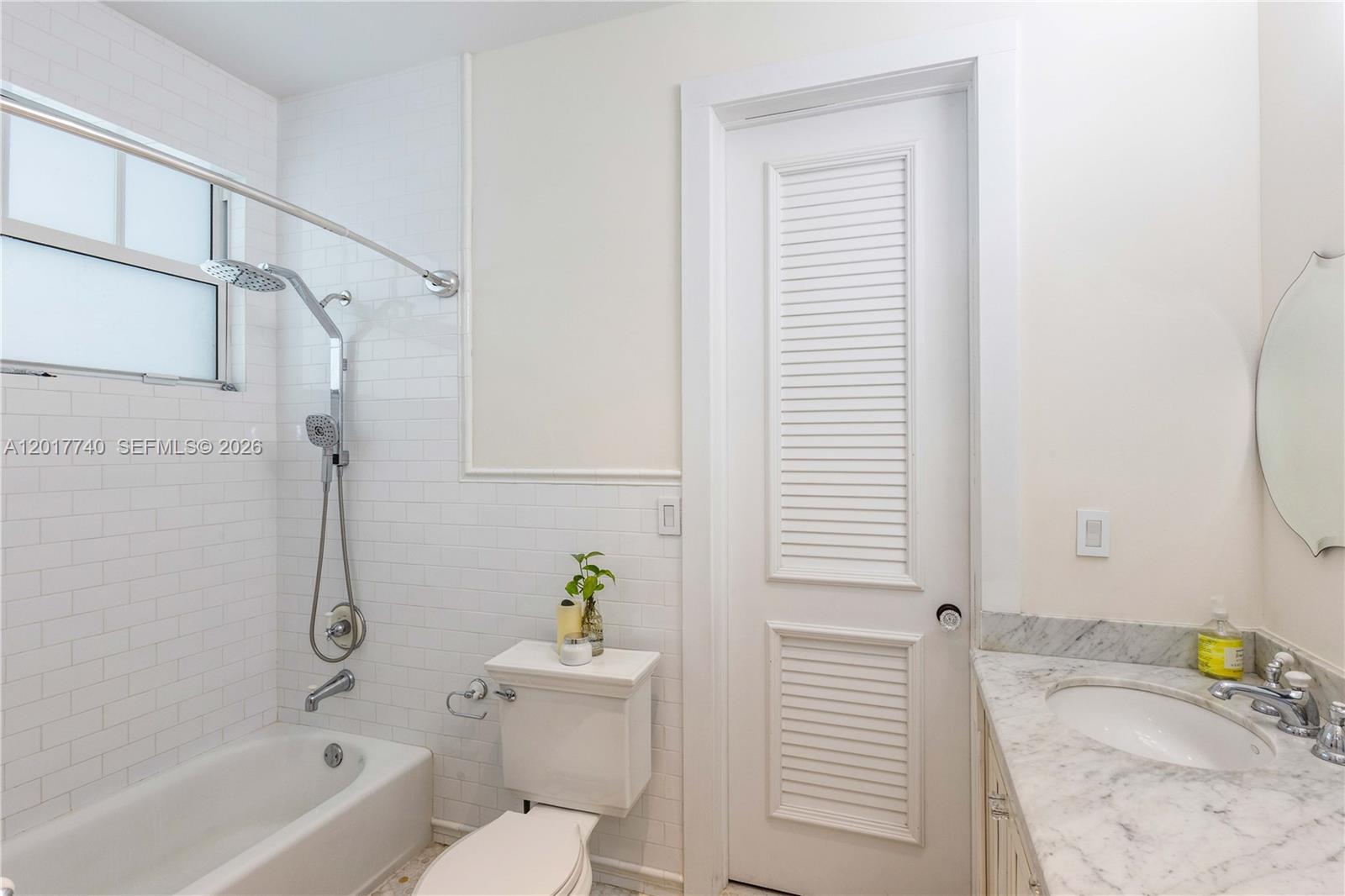 6845 Southwest 98th Street Pinecrest, FL 33156 - Photo 16 of 23 a bathroom with a sink and a bathtub with shower