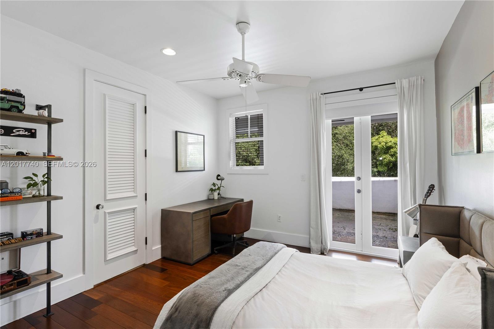 6845 Southwest 98th Street Pinecrest, FL 33156 - Photo 17 of 23 a bedroom with a bed and a chandelier