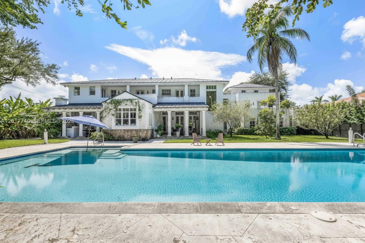 6845 Southwest 98th Street Pinecrest, FL 33156 - Photo 20 of 23 a front view of a house with swimming pool having outdoor seating