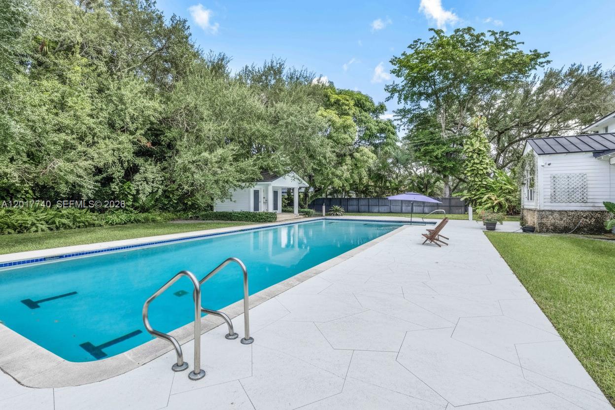 6845 Southwest 98th Street Pinecrest, FL 33156 - Photo 22 of 23 a view of swimming pool with a yard