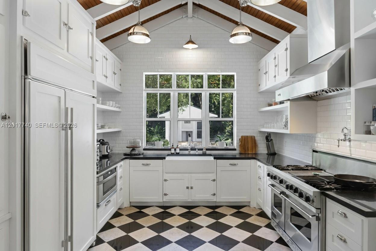 6845 Southwest 98th Street Pinecrest, FL 33156 - Photo 3 of 23 a kitchen with stainless steel appliances a stove a sink and a refrigerator
