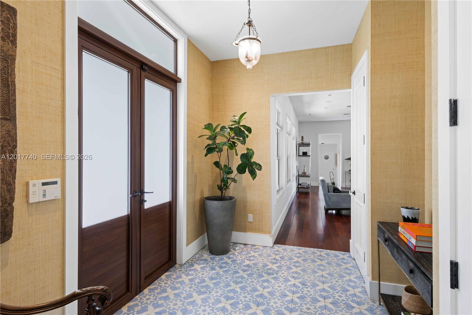 6845 Southwest 98th Street Pinecrest, FL 33156 - Photo 7 of 23 a view of a hallway to a livingroom and a dining room with furniture