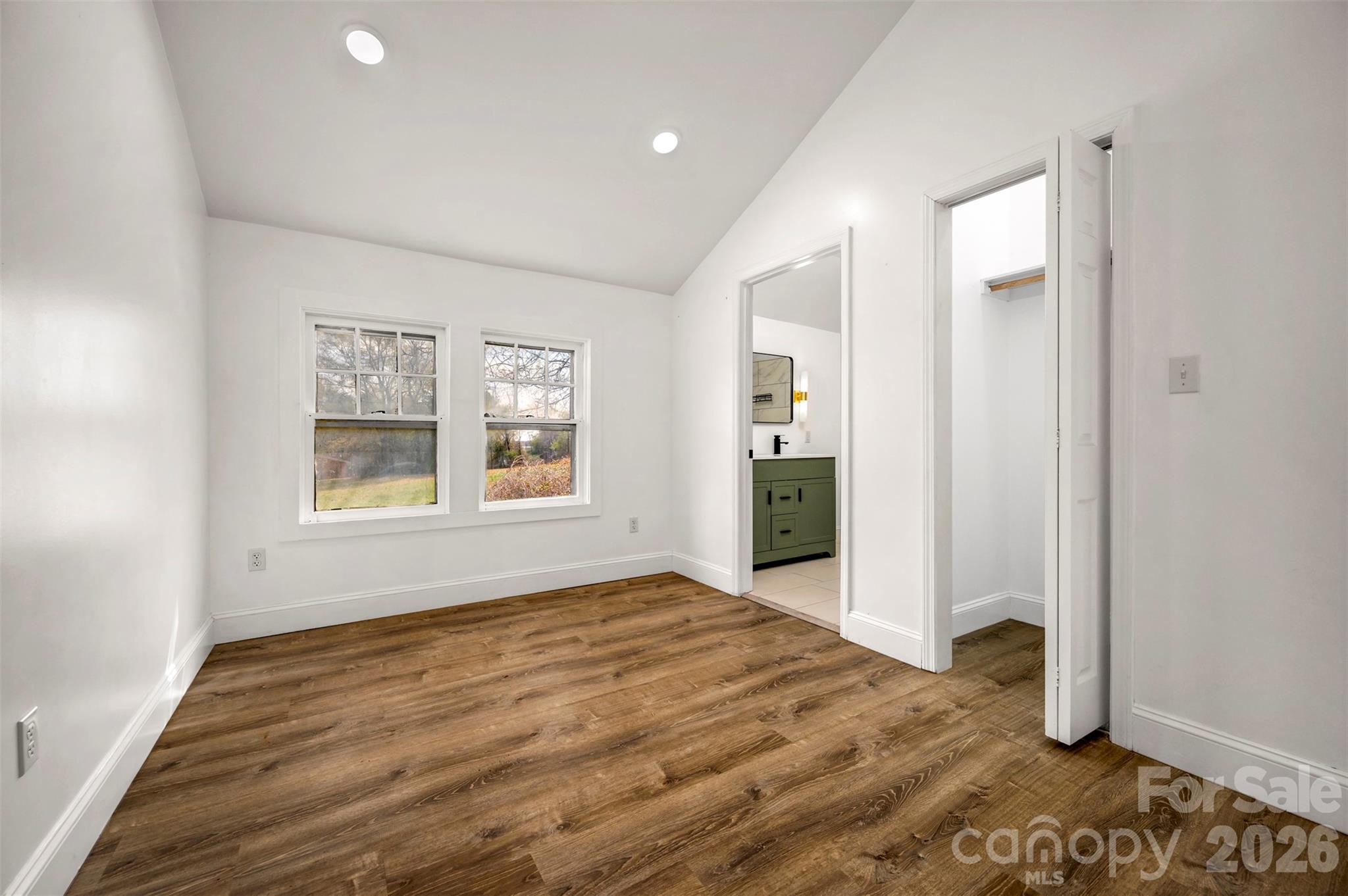 162 Miller Street Spindale, NC 28160 - Photo 11 of 27 a view of an empty room with window and wooden floor
