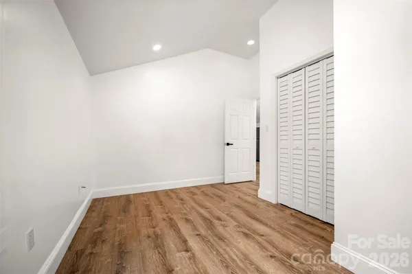 a view of a room with wooden floor and white walls
