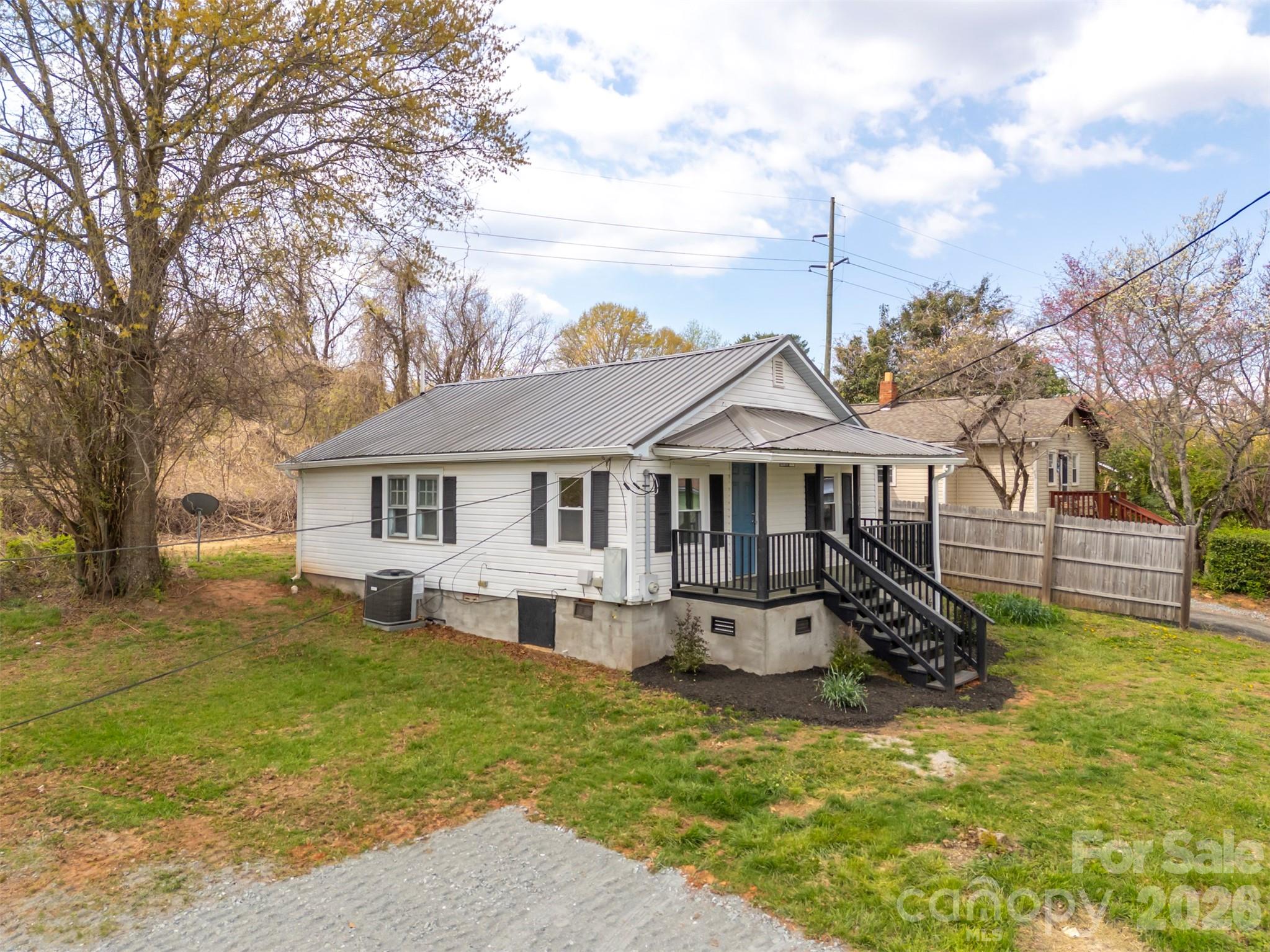 162 Miller Street Spindale, NC 28160 - Photo 22 of 27 a front view of a house with a yard table and chairs