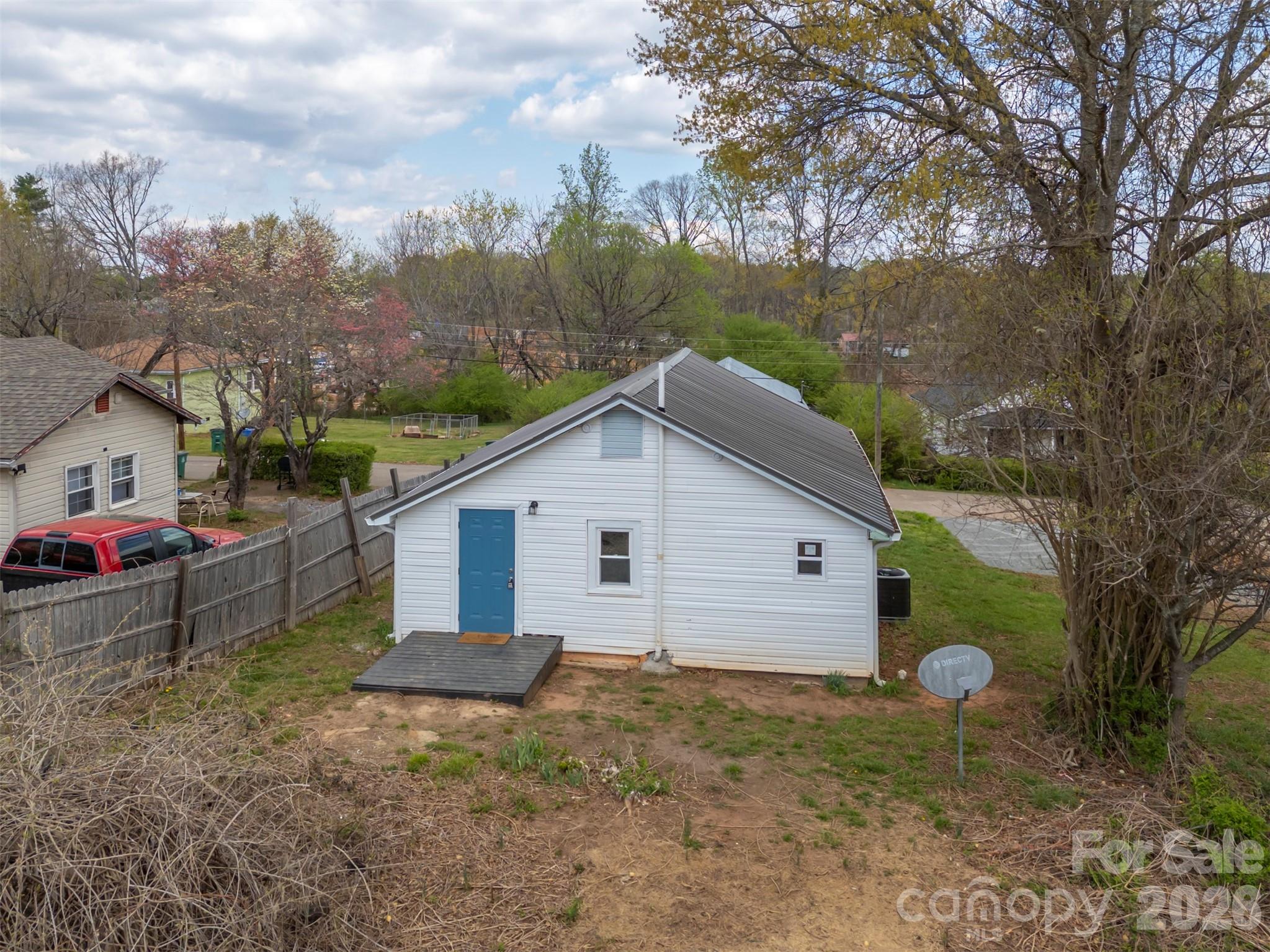 162 Miller Street Spindale, NC 28160 - Photo 25 of 27 a view of a backyard with a barn and a large tree