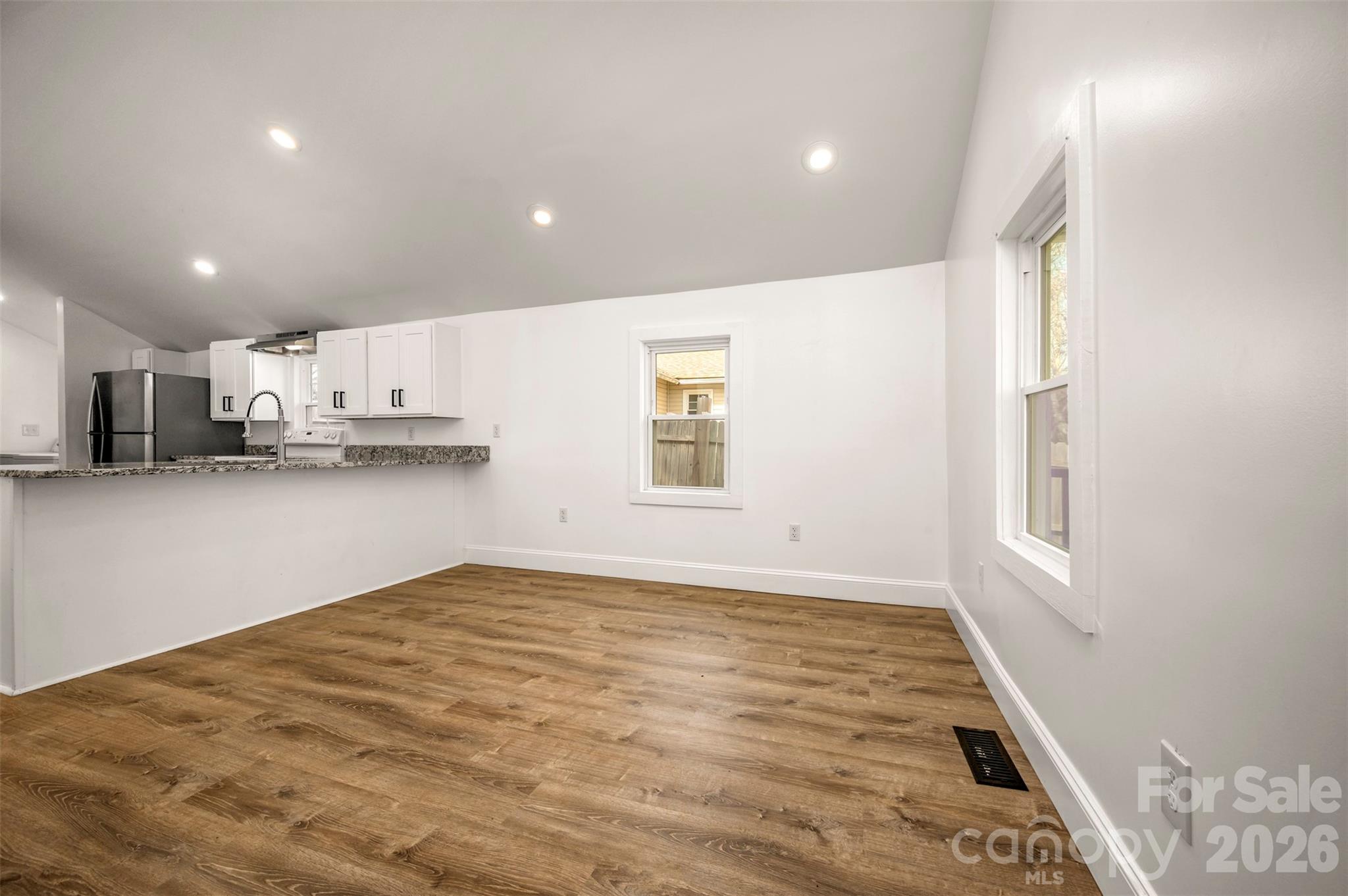 162 Miller Street Spindale, NC 28160 - Photo 5 of 27 a view of kitchen with window and wooden floor