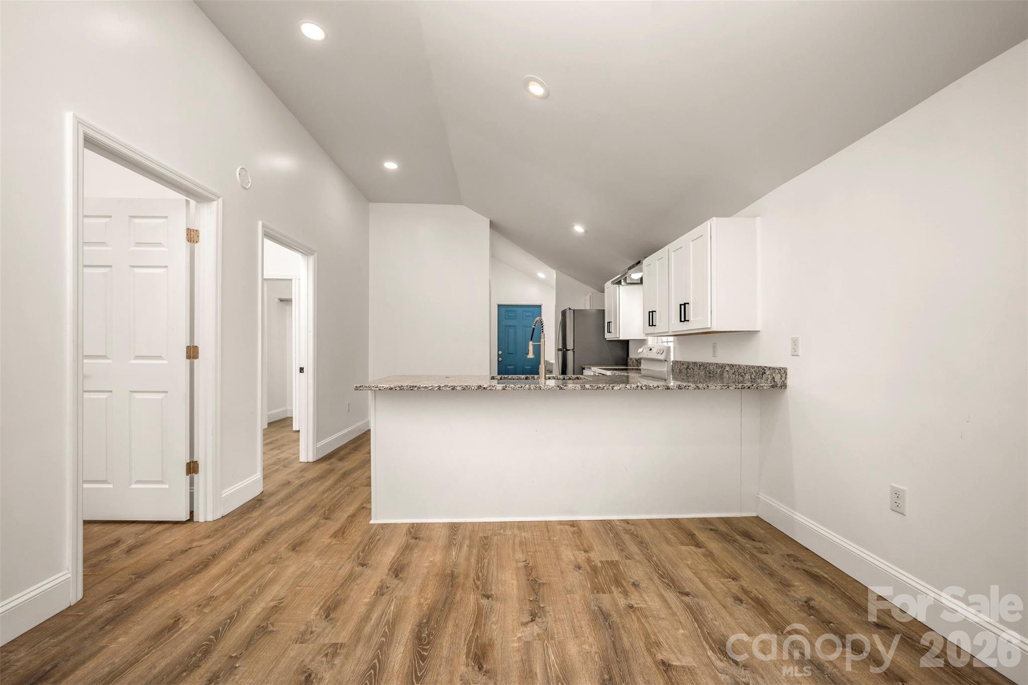 162 Miller Street Spindale, NC 28160 - Photo 6 of 27 a view of kitchen with refrigerator and white cabinets