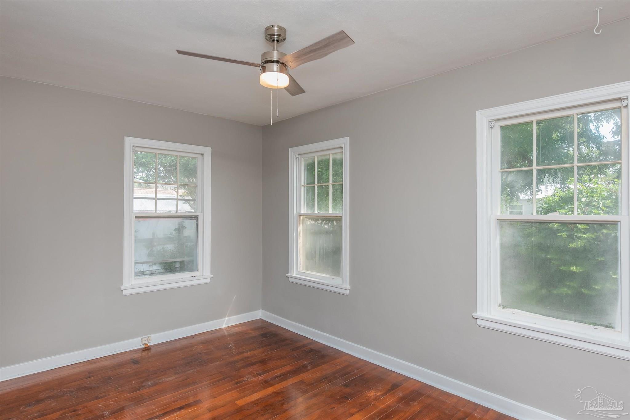 225 Bryant Road Pensacola, FL 32507 - Photo 12 of 21 a view of a big room with wooden floor and windows