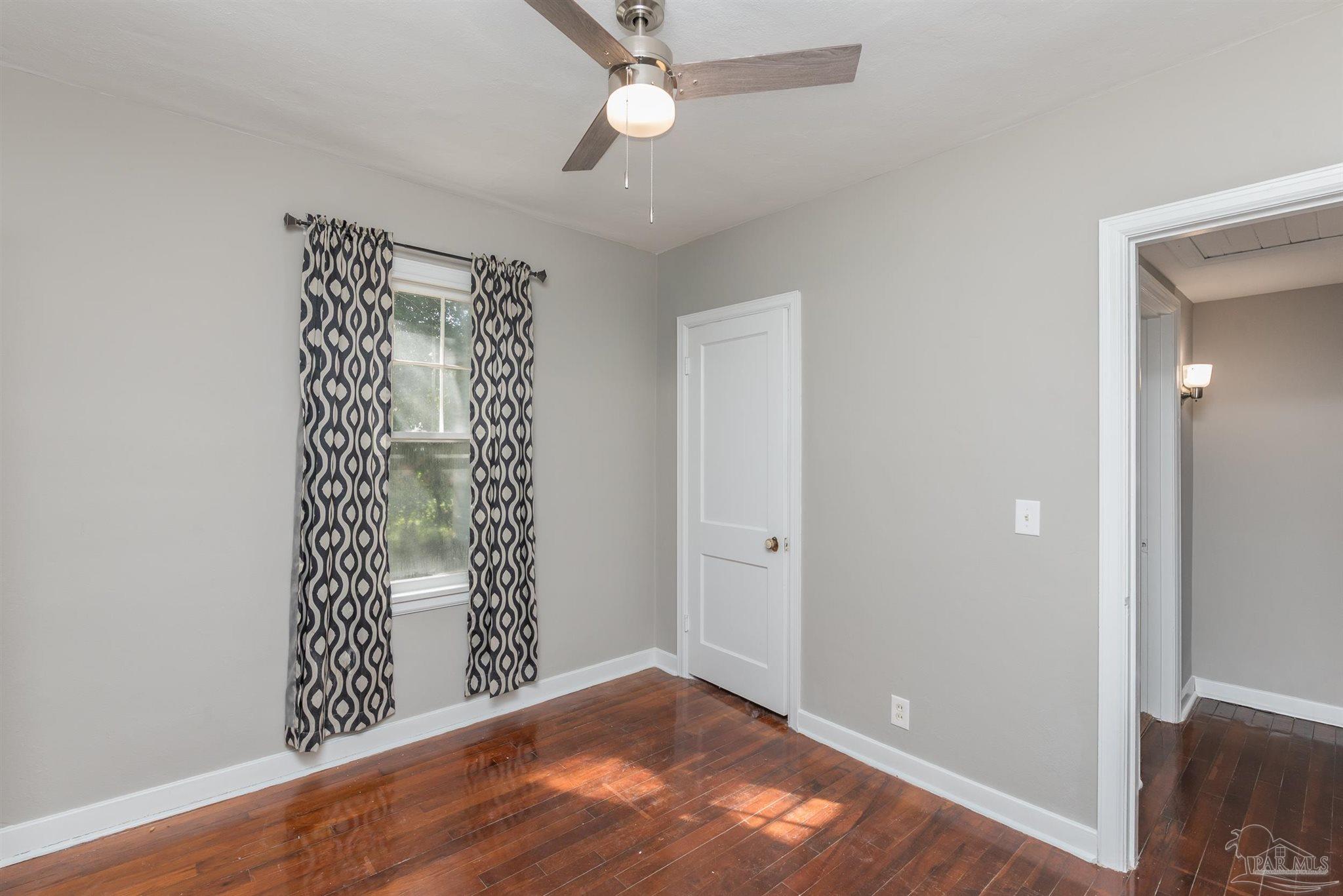 225 Bryant Road Pensacola, FL 32507 - Photo 15 of 21 wooden floor in an empty room with a window