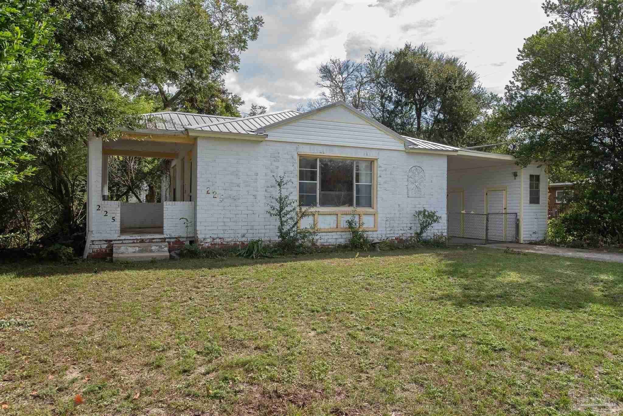 225 Bryant Road Pensacola, FL 32507 - Photo 21 of 21 a backyard of a house with potted plants and large tree