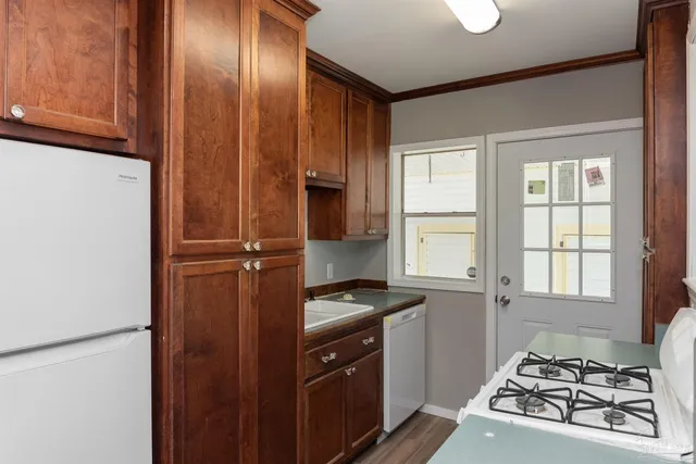 a kitchen with stainless steel appliances granite countertop a stove a sink and a refrigerator