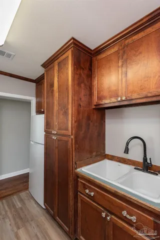 a kitchen with a sink and refrigerator